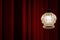 Classic theater, cinema, foyer background with red velved curtain and old vintage lamp