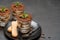 Classic tiramisu dessert in a glass and savoiardi cookies on dark concrete background