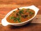 Classic Traditional Indian Lamb Dish, Mutton Rogan Josh served over a rustic wooden background, selective focus