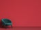 Classic tufted chair in emerald green on red background with cop