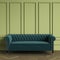 Classic Tufted sofa emerald color standing in classic interior. Green walls with mouldings,floor parquet oak Herringbone