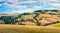 Classic Tuscan view with farmhouse and cypress trees. Colorful summer view of Italian countryside, Val d`Orcia valley, San Quiric