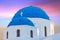 Classic view of blue dome church in Santorini.