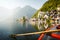 Classic view of Hallstatt with traditional rowing boat in summer, Salzkammergut region, Austria