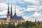 Classic view of the Notre-Dame Cathedral in Luxembourg with high spires and the flag of the country