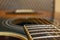 Classic vintage acoustic guitar with visible frats and wires. Close-up view