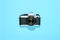 Classic vintage reflex camera centered on blue