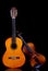 Classic violin and wooden guitar against dark backdrop