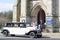 A classic wedding car, bride, bridesmaid at the door before ceremony