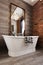Classic white freestanding iron look bathtub in renovated bathroom