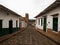 Classic white green house walls and cobblestone streets in colonial historical village town of Barichara Colombia