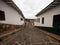 Classic white green house walls and cobblestone streets in colonial historical village town of Barichara Colombia