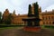 Classic wide-angle landscape view of medieval building with back yard and vintage well in Chernivtsi University.