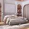 Classic wooden bedroom with master bed, parquet floor, niches and carpet in white and beige tones. Arched door with curtains and