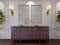 Classic wooden chest of drawers with sliding cabinets and empty paintings and sconces on the wall in the dining room