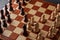 Classic Wooden Tournament chess set on black background. Chessboard with pieces. Arrangement of the pieces stems from an opening