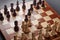 Classic Wooden Tournament chess set on black background. Chessboard with pieces. Arrangement of the pieces stems from an opening