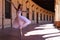 Classical ballet dancer dancing and doing different ballet postures. The ballerina is wearing a white tutu. Ballet concept