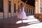 Classical ballet dancer dancing and doing different ballet postures. The ballerina is wearing a white tutu. Ballet concept
