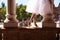 Classical ballet dancer dancing between two white marble columns. She is wearing a white tutu and the photo is backlit. The photo