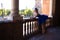 Classical ballet dancer in peacock blue tutu leaning on a railing and looking at the horizon. The ballerina is pretty and young.