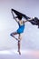 Classical Ballet Ideas. Young Japanese Female Ballet Dancer Dancing With Flying Black Cloth While Posing in Blue Bodysuit Against