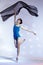 Classical Ballet Ideas. Young Japanese Female Ballet Dancer Dancing With Flying Black Cloth While Posing in Blue Bodysuit On White