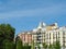 Classical elegant buildings seen though vivid park greenery on Plaza del Oriente, Madrid, Spain. Vintage Spanish architecture