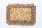 Classical frame made of burlap with grains of oats