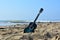 A classical guitar on the beach in front of the sea