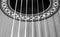 Classical guitar: strings and rosette. Black and white photo