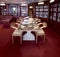 Classical library room with leather armchairs, stone table and World Atlas