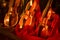 Classical music instruments violins on red velvet illuminated by lights from lamps