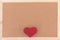 Classical plain brown cork board with red knitting heart at bottom of frame