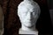 Classical plaster head bust on black background