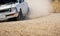 Classical rally racing car on dirt road