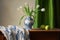 Classical still life with a blue white hand painted vase and tulips, green curtains in the background