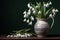 Classical still life with snowdrops in a ceramic vase. Springtime flowers