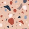 Classical Terrazzo texture with red, blue, white and gray sprinkles or crumbs scattered on light background. Modern