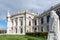 Classical, typical Viennese architecture in the middle of the old city centre, with white clouds and blue sky above. A large rock