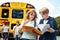 Classmates going to school by bus boys close-up with books checking assignment