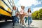 Classmates running from school bus back home looking forward smiling happy