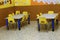 Classroom of a preschool with the little yellow chairs