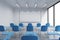 A classroom or presentation room in a modern university or fancy office. Blue chairs, a whiteboard on the wall and panoramic windo