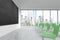 A classroom or presentation room in a modern university or fancy office. Green chairs, a black chalkboard on the wall and panorami