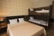 Classy hotel bedroom interior design. Large bed, bunk-beds. Family room with brown color tone furniture