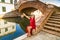 Classy woman sitting on bridge