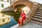 Classy woman sitting on bridge