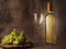 Claster of fresh juicy white grapes on a wooden board and glass and bottle of white wine on hessian cloth background. Still life,