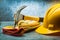 Claw hammer construction leather gloves and yellow helmet on metalic background